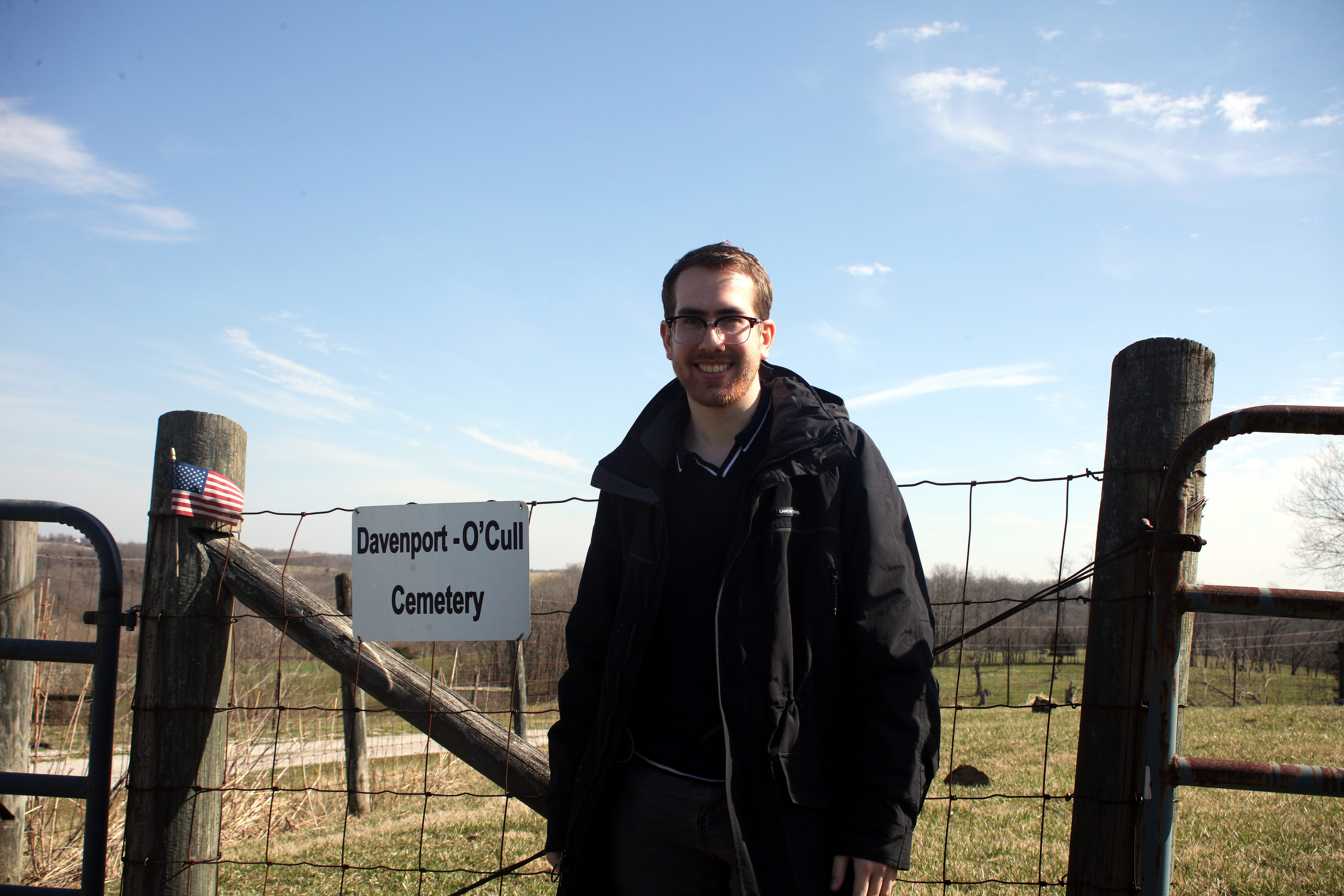 Max O'Cull standing next to the O'Cull cemetery